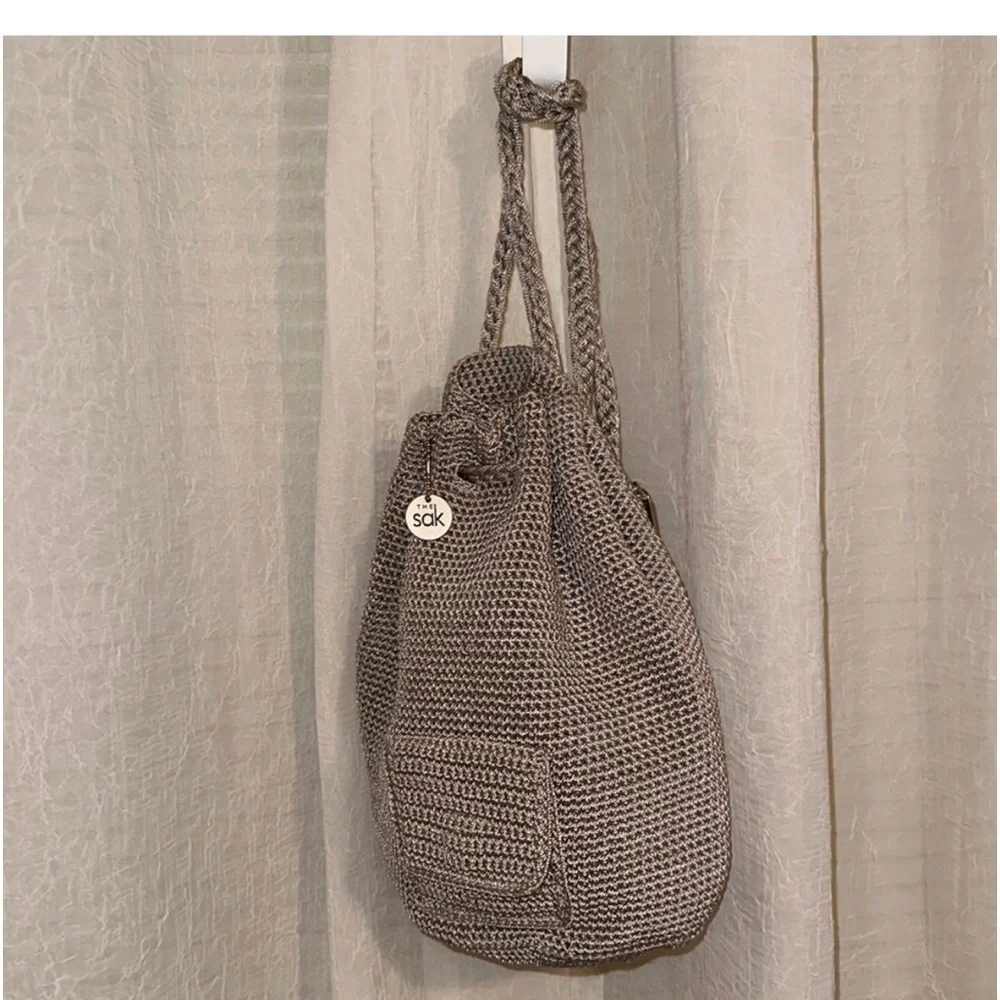 The Sak sling Backpack in the color mushroom